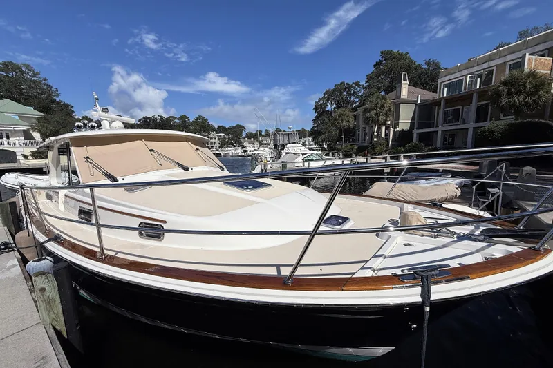 Slide: The Image of 2023 Sabre 43 Salon Express yacht docked at a marina under a clear blue sky. - 31