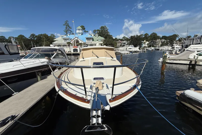 Slide: The Image of 2023 Sabre 43 Salon Express yacht docked at a marina under a clear blue sky. - 32