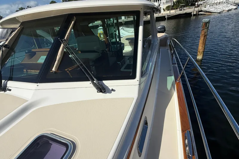 Slide: The Image of 2023 Sabre 43 Salon Express yacht docked at marina, showcasing sleek design and spacious deck. - 41