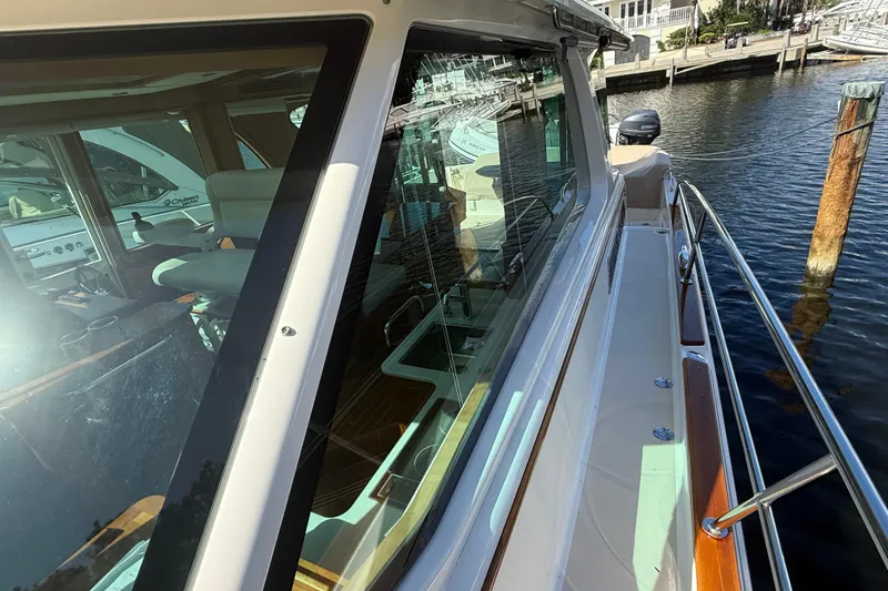 Slide: The Image of 2023 Sabre 43 Salon Express yacht docked, showcasing sleek design and luxurious interior. - 43