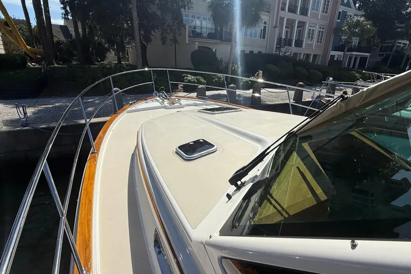 Slide: The Image of 2023 Sabre 43 Salon Express yacht docked near waterfront homes. - 44