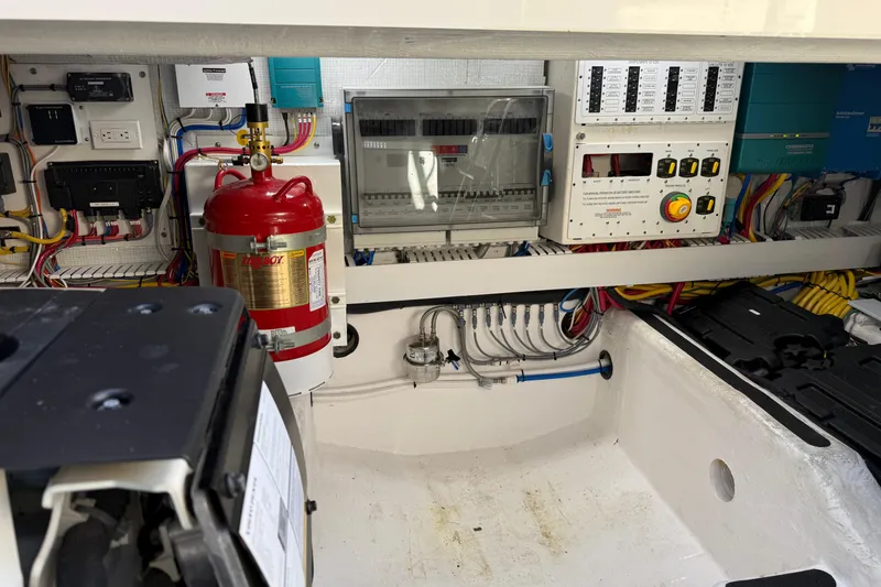 Slide: The Image of Engine room of 2023 Sabre 43 Salon Express with electrical panels and fire extinguisher. - 49