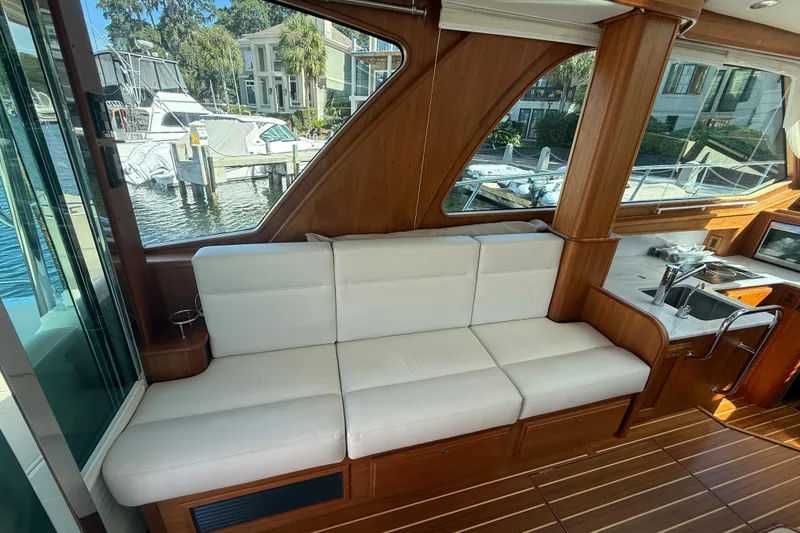 Slide: The Image of Interior of 2023 Sabre 43 Salon Express yacht with white seating and wooden accents. - 54