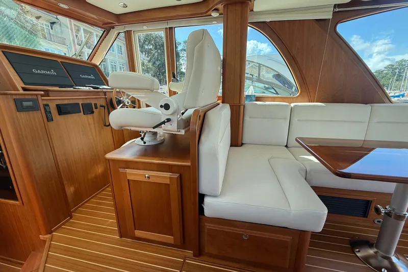 Slide: The Image of 2023 Sabre 43 Salon Express interior with white seating and wooden accents. - 56