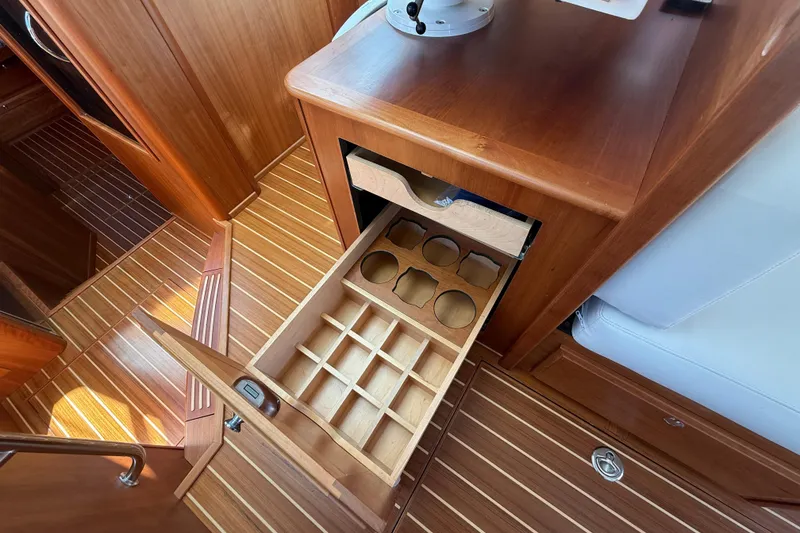 Slide: The Image of 2023 Sabre 43 Salon Express interior with open wooden storage drawers. - 58