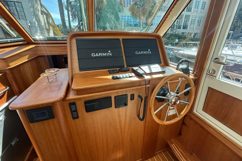 Slide: The Image of 2023 Sabre 43 Salon Express helm with Garmin displays and wooden steering wheel. - 59