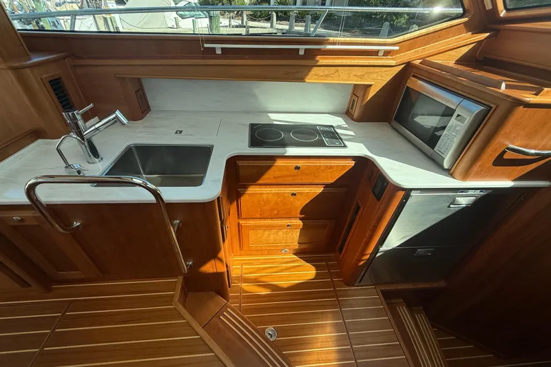 Slide: The Image of Luxurious 2023 Sabre 43 Salon Express yacht kitchen with modern appliances and wooden cabinetry. - 63