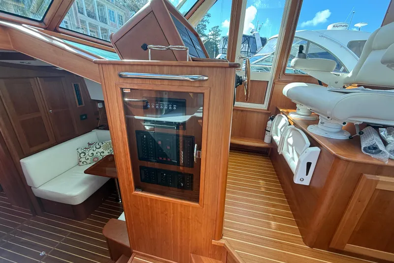Slide: The Image of 2023 Sabre 43 Salon Express interior with wood finish and seating area. - 66
