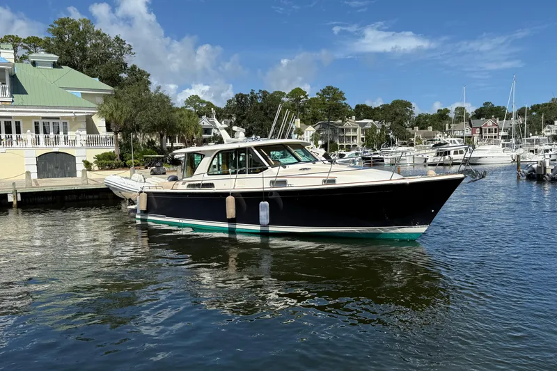 Slide: The Image of 2023 Sabre 43 Salon Express yacht docked in a scenic marina setting. - 7