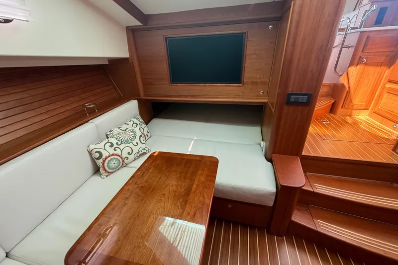 Slide: The Image of 2023 Sabre 43 Salon Express interior with wooden finish and cozy seating area. - 72
