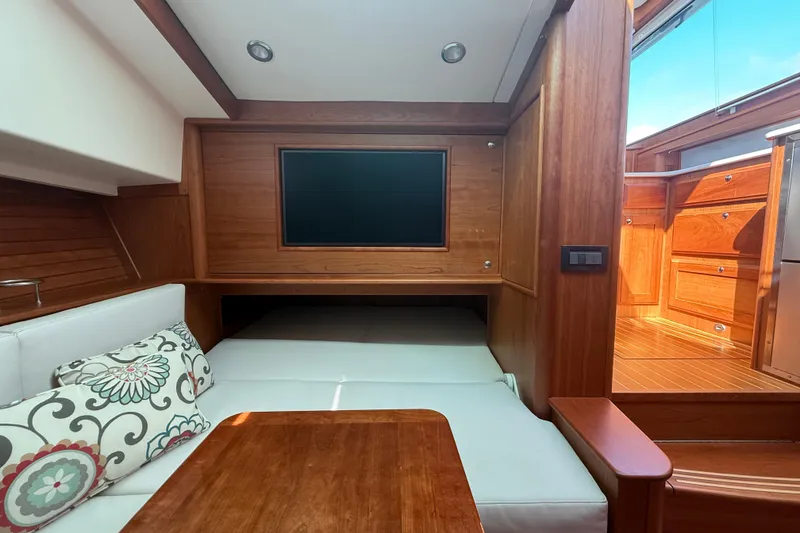 Slide: The Image of Interior of 2023 Sabre 43 Salon Express yacht with wood finish and cozy seating area. - 74