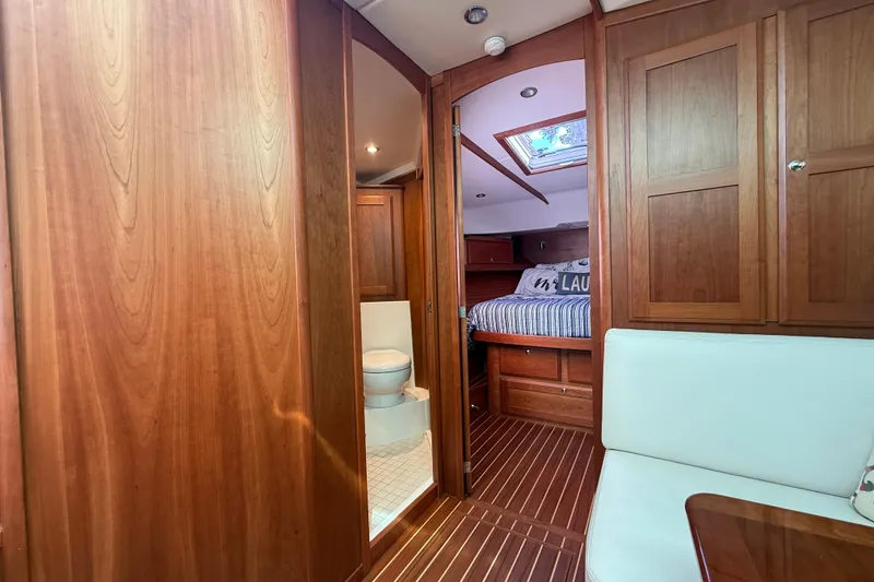 Slide: The Image of 2023 Sabre 43 Salon Express interior with wood finish, bedroom, and bathroom. - 77