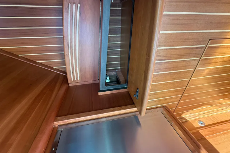 Slide: The Image of 2023 Sabre 43 Salon Express interior with open wooden cabinet and sleek design. - 79