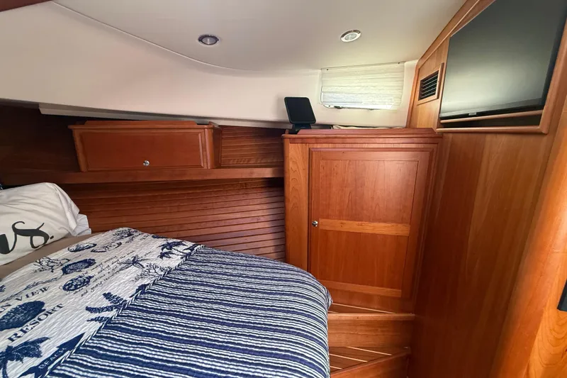 Slide: The Image of 2023 Sabre 43 Salon Express cabin with wood paneling and cozy bedding. - 80