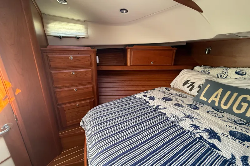 Slide: The Image of 2023 Sabre 43 Salon Express cabin with wooden cabinetry and cozy bedding. - 81