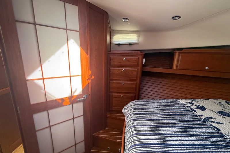 Slide: The Image of Luxurious 2023 Sabre 43 Salon Express cabin with elegant wood cabinetry and cozy bedding. - 82