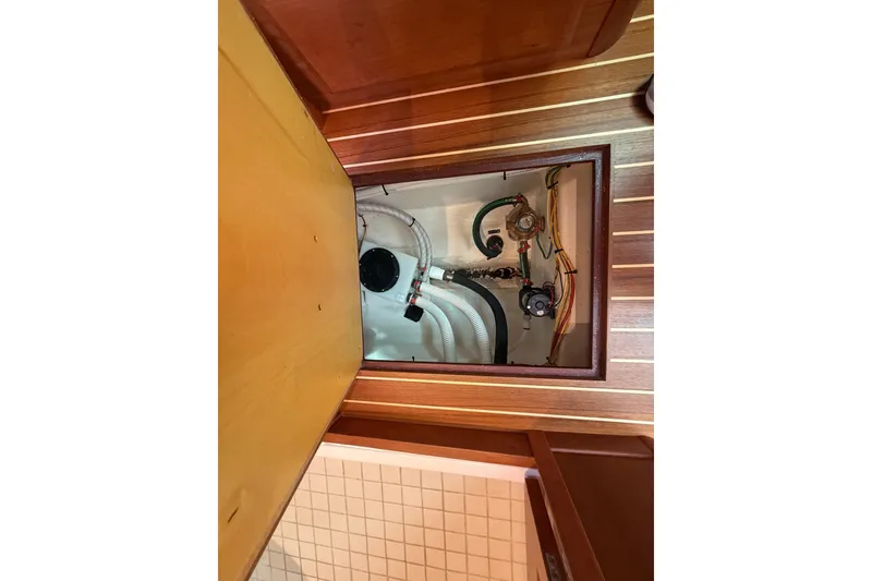 Slide: The Image of 2023 Sabre 43 Salon Express engine compartment with visible hoses and wiring. - 86