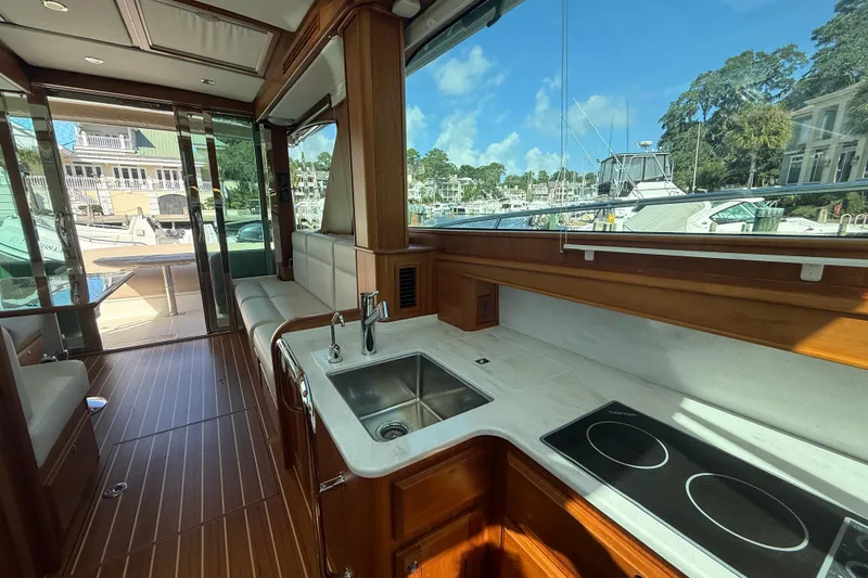 Slide: The Image of Interior of 2023 Sabre 43 Salon Express yacht with modern kitchen and scenic marina view. - 87