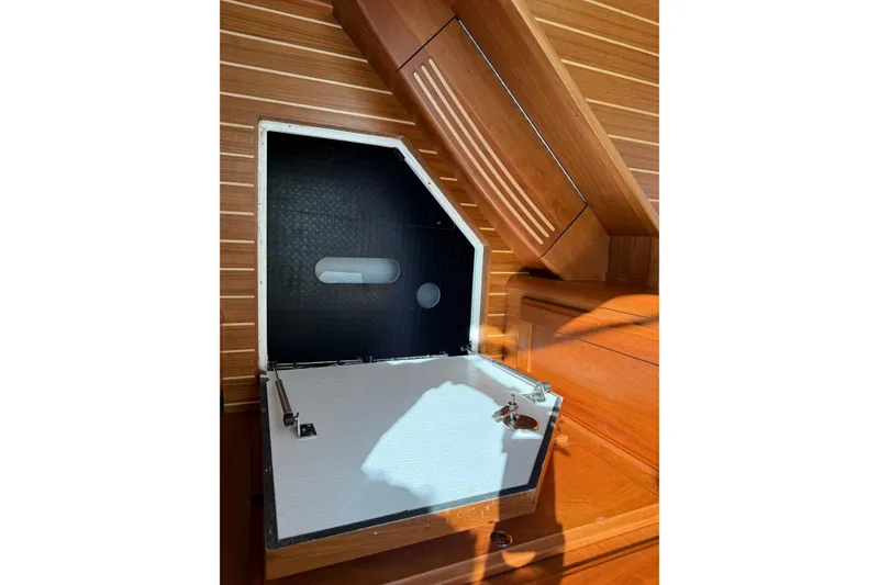 Slide: The Image of 2023 Sabre 43 Salon Express interior storage compartment with wooden finish. - 89