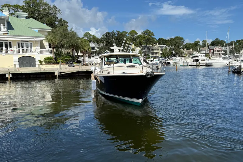 Slide: The Image of 2023 Sabre 43 Salon Express yacht docked in a scenic marina setting. - 9