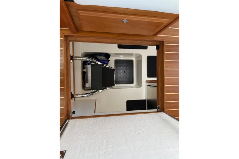 Slide: The Image of 2023 Sabre 43 Salon Express interior hatch with wooden finish and storage space. - 91