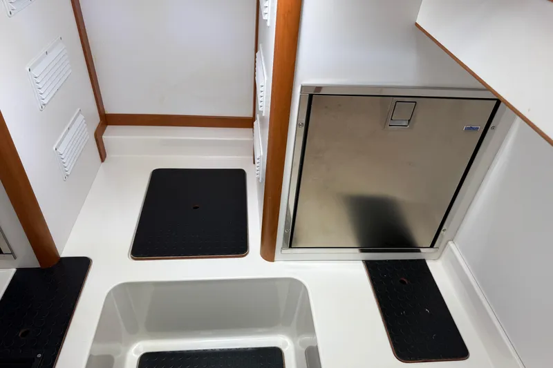 Slide: The Image of 2023 Sabre 43 Salon Express interior with stainless steel door and black floor mats. - 92