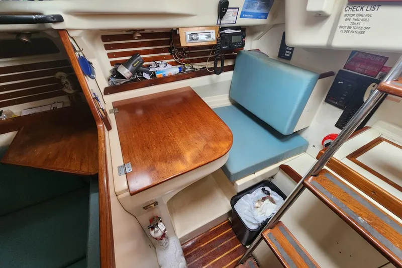 Slide: The Image of Interior of a 1982 Pearson 323 sailboat with cozy seating and nautical decor. - 31