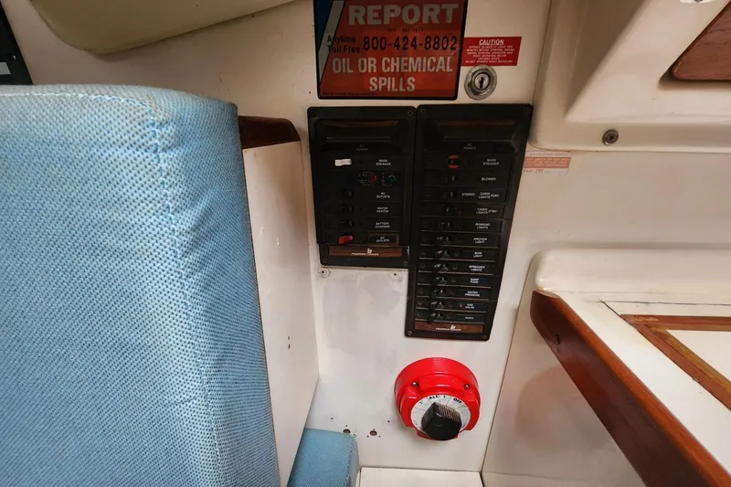 Slide: The Image of Interior of a 1982 Pearson 323 sailboat with blue seating and wooden accents. - 35