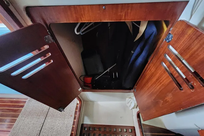 Slide: The Image of 1982 Pearson 323 yacht galley with sink, storage, and wooden accents. - 37