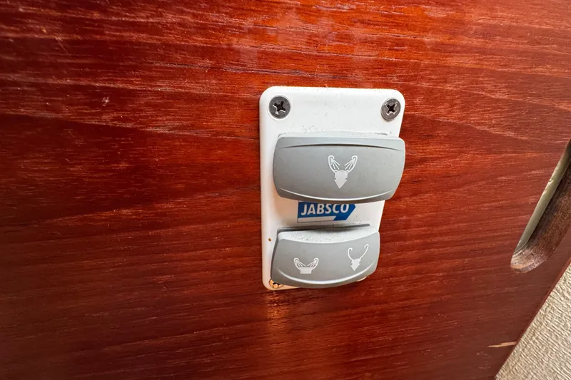 Slide: The Image of Jabsco switch panel on 1982 Pearson 323 boat with wooden background. - 51