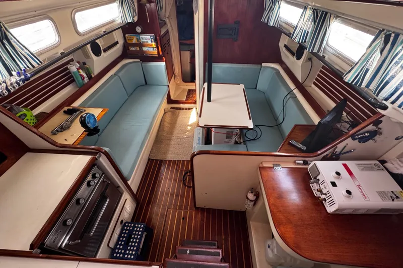 Slide: The Image of Interior of a 1982 Pearson 323 sailboat with cozy seating and nautical decor. - 66