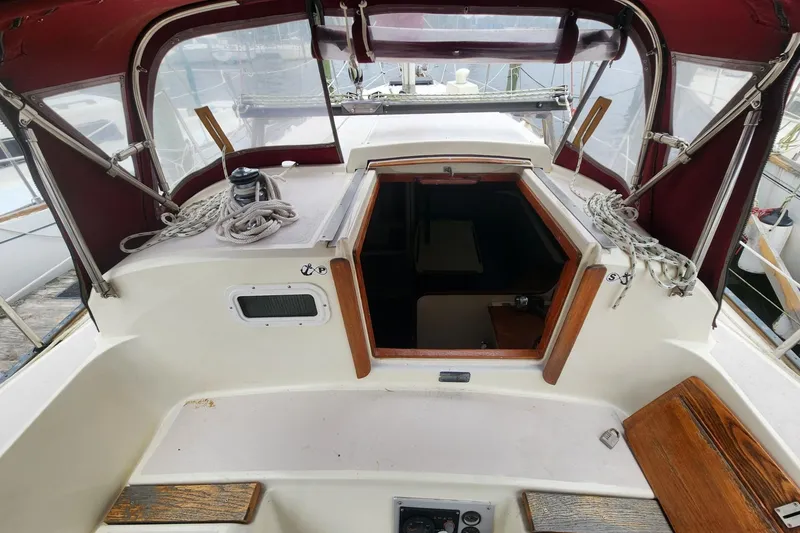 Slide: The Image of 1982 Pearson 323 sailboat cockpit with ropes and wooden accents. - 13