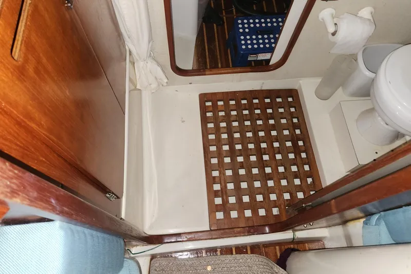Slide: The Image of 1982 Pearson 323 yacht bathroom with wooden grate flooring and compact toilet. - 14