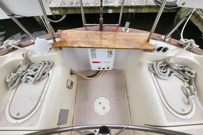 Slide: The Image of Cockpit of a 1982 Pearson 323 sailboat with ropes and wooden seating. - 18