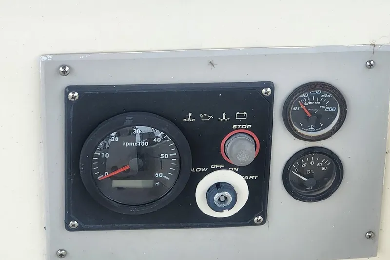 Slide: The Image of Control panel of a 1982 Pearson 323 sailboat with gauges and switches. - 23