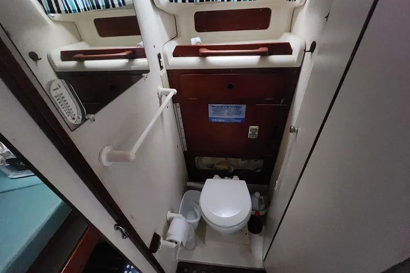Slide: The Image of Compact bathroom in 1982 Pearson 323 sailboat with toilet and storage. - 39