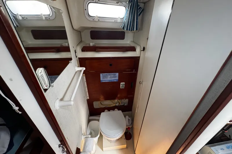 Slide: The Image of Compact bathroom in 1982 Pearson 323 sailboat with toilet and storage. - 52