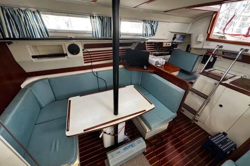 Slide: The Image of Interior of 1982 Pearson 323 sailboat with blue seating and wooden accents. - 67