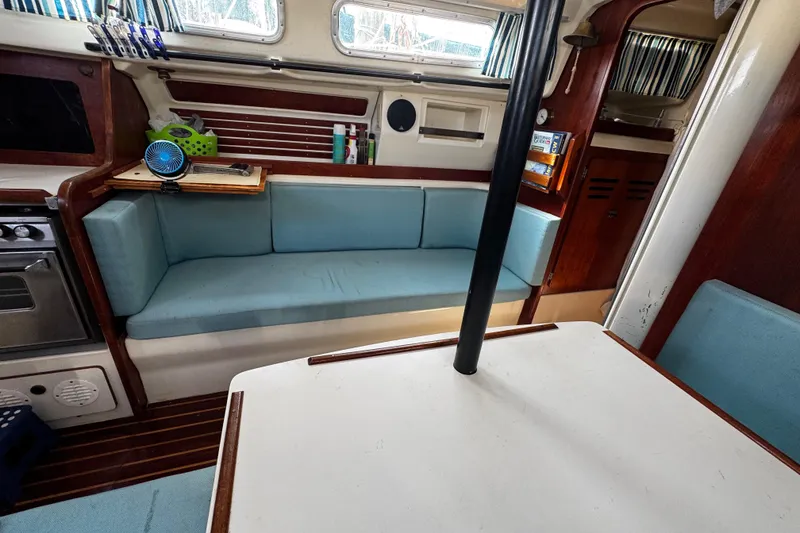 Slide: The Image of Interior of 1982 Pearson 323 sailboat with blue seating and wooden accents. - 69