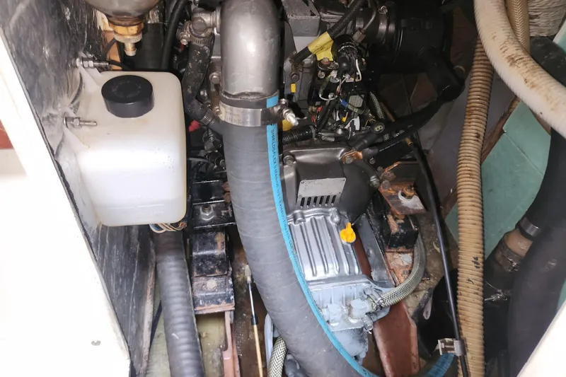 Slide: The Image of Engine compartment of a 1982 Pearson 323 sailboat, showing various mechanical components. - 79