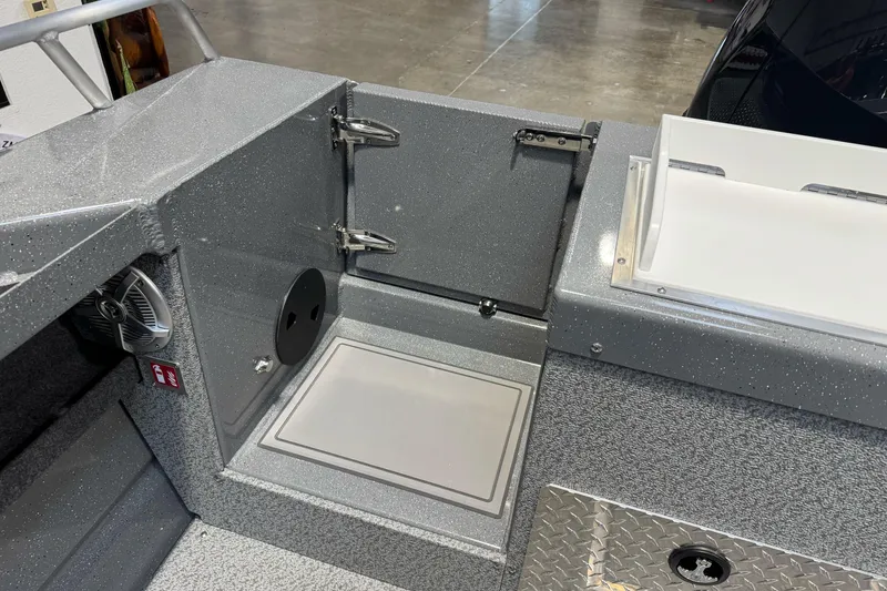 Slide: The Image of Interior of 2026 Lund 200 Heavy Gauge boat, featuring storage compartments and metallic finish. - 15