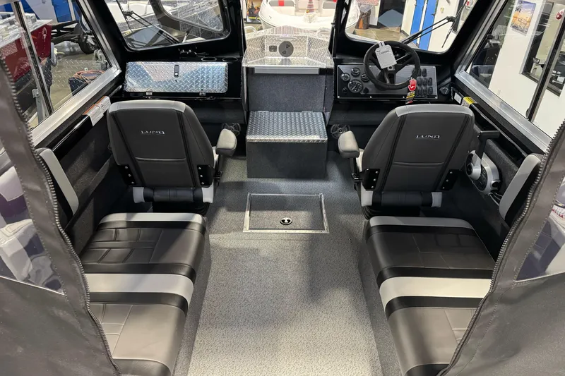 Slide: The Image of 2026 Lund 200 Heavy Gauge boat interior with modern seating and steering console. - 22