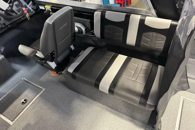 Slide: The Image of 2026 Lund 200 Heavy Gauge boat interior with black and gray seating. - 24