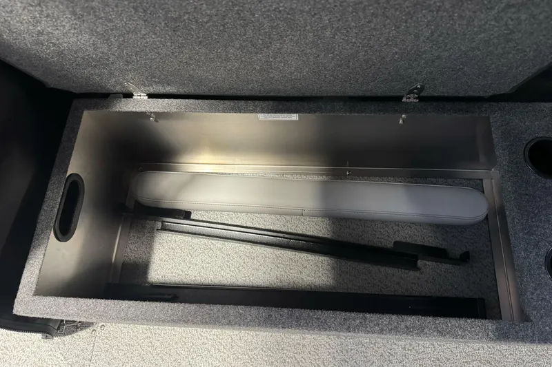 Slide: The Image of Open storage compartment in 2026 Lund 200 Heavy Gauge boat, featuring carpeted interior. - 25