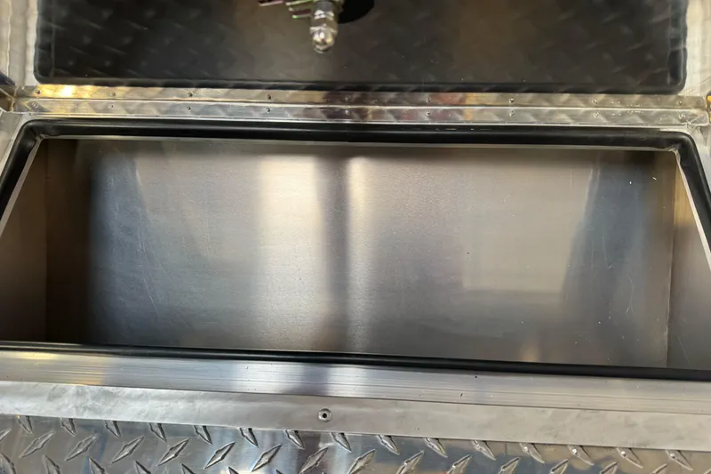 Slide: The Image of Open storage compartment of 2026 Lund 200 Heavy Gauge boat with metal finish. - 30