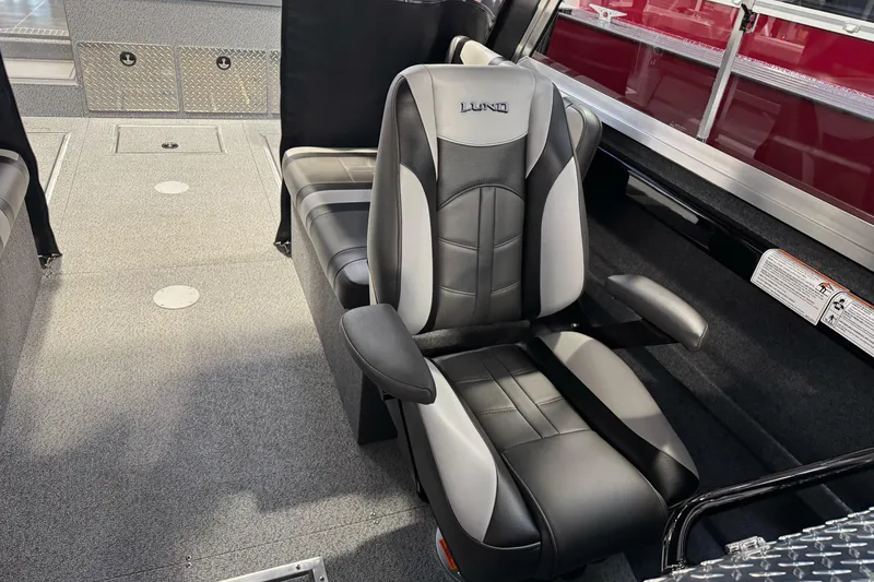 Slide: The Image of 2026 Lund 200 Heavy Gauge boat interior with black and gray seating. - 34