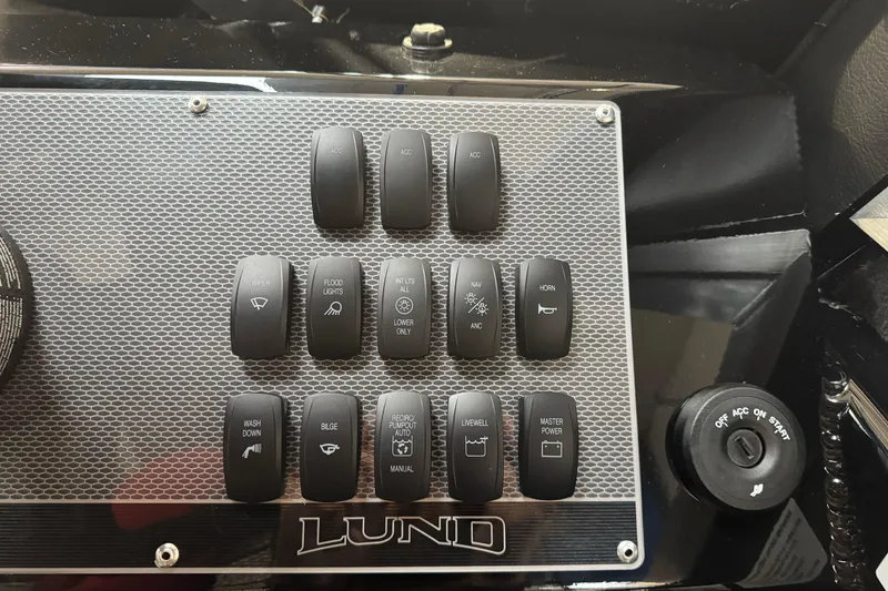 Slide: The Image of Control panel of 2026 Lund 200 Heavy Gauge boat with labeled switches. - 36