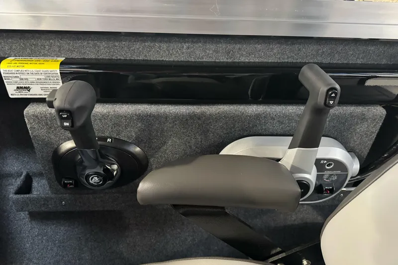 Slide: The Image of 2026 Lund 200 Heavy Gauge boat controls with dual levers and textured panel. - 38