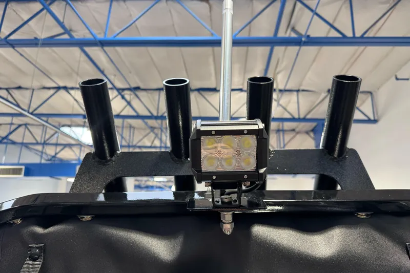 Slide: The Image of 2026 Lund 200 Heavy Gauge boat with mounted LED light and rod holders. - 42