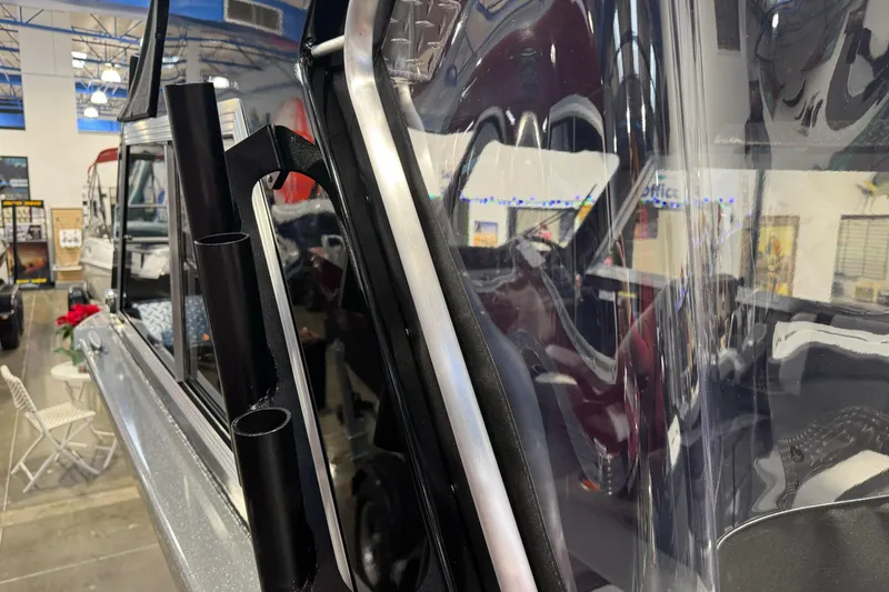 Slide: The Image of 2026 Lund 200 Heavy Gauge boat interior with rod holders, showroom display. - 43